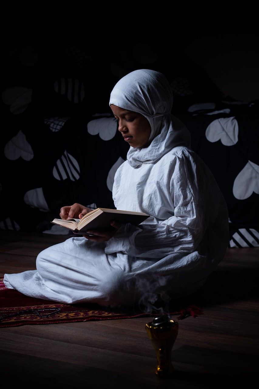 Young girl reading the Quran at home